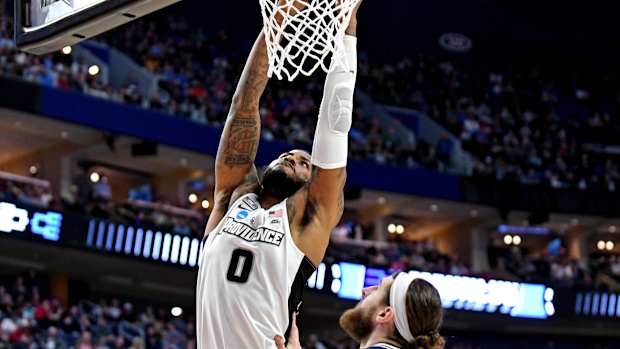 Mar 19, 2022; Buffalo, NY, USA; Providence Friars center Nate Watson (0) dunks the ball against Richmond Spiders forward Grant Golden (33) during the second round of the 2022 NCAA Tournament at KeyBank Center. Mandatory Credit: Mark Konezny-USA TODAY Sports